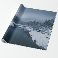 RIVER SURROUNDED BY SNOW COVERED FIELD WITH PINE T