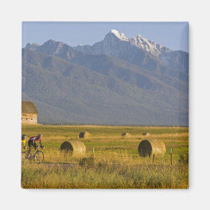 Road bicyclists race down back country road in magnet