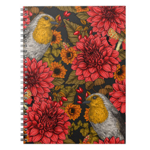 Robins in the autumn garden, red dahlias on black notebook