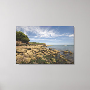 Rocky Seaside With Motorboat Travelling Canvas Print
