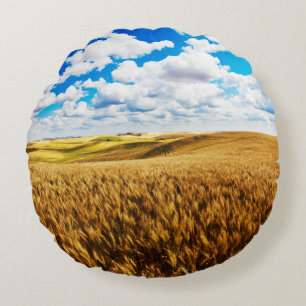 Rolling hills of ripe wheat round cushion