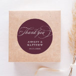 Romantic Calligraphy Burgundy Wedding Thank You Classic Round Sticker<br><div class="desc">This burgundy and white thank you wedding sticker featuring elegant and romantic swirly calligraphy lettering with your names and date. For more advanced customisation of this design,  please click the BLUE DESIGN TOOL BUTTON above!</div>