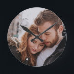Romantic First Year Custom Photo Round Clock<br><div class="desc">Remember your first Christmas with a holiday photo, or one from your engagement or wedding. Your favourite photo, and personalisations can be whatever name, date or event you wish to place in the 2 text boxes. Handwritten look. Replace stock photo with your own, reverses to burgundy magenta colour with your...</div>