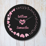Romantic Heart custom Couple Name Love Large Clock<br><div class="desc">Celebrate love every second with this elegant personalised wall clock featuring a romantic design of pink hearts on a black background. The centre showcases two custom names above and below a heart motif, making it perfect for couples, anniversaries, weddings, or Valentine's Day. A thoughtful gift and a stylish addition to...</div>