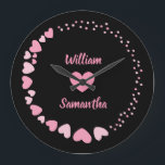 Romantic Heart custom Couple Name Love Large Clock<br><div class="desc">Celebrate love every second with this elegant personalised wall clock featuring a romantic design of pink hearts on a black background. The centre showcases two custom names above and below a heart motif, making it perfect for couples, anniversaries, weddings, or Valentine's Day. A thoughtful gift and a stylish addition to...</div>