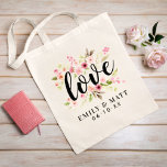 Romantic Love Pink Floral Couple Names Tote Bag<br><div class="desc">"Love" in playful black script sits atop a beautiful arrangement of pink watercolor blooms and lush greenery with personalized couple names and wedding date curving below. A charming design that works as a wedding welcome bag, bridal party favor, or keepsake for the newlyweds. All text including names and date are...</div>