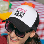 Rose the Day Away Trucker Hat<br><div class="desc">Is there any better way to spend a hot summer Saturday? We think not. Rose the day away with this fun design featuring the quote in modern block text.</div>