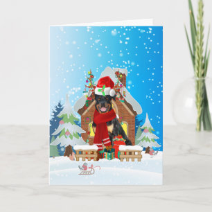 Rottweiler in snow with Christmas gifts  Card