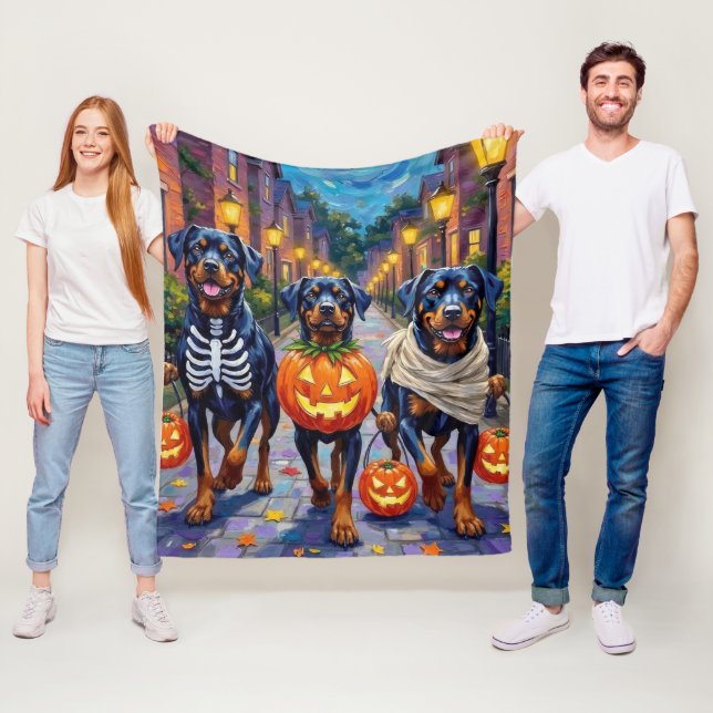 Rottweiler Trick-or-Treating In Halloween Costumes Fleece Blanket (In Situ)