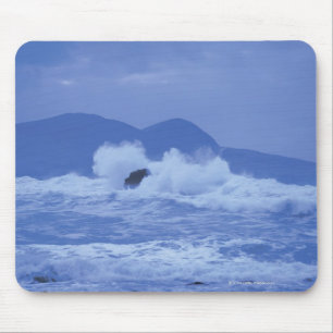rough seas crashing against a rocky shore mouse mat