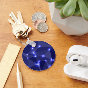 Round keychain featuring dark blue geometric shape