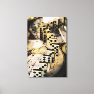 Row of dominoes on old world map canvas print