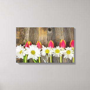 row of tulips and daisies on wood canvas print
