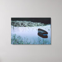 Rowboat on small lake surrounded by water
