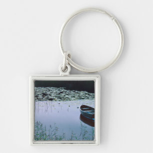 Rowboat on small lake surrounded by water key ring