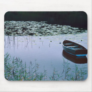 Rowboat on small lake surrounded by water mouse mat