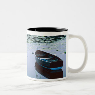 Rowboat on small lake surrounded by water Two-Tone coffee mug
