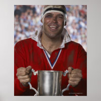 Rugby player holding trophy cup, portrait
