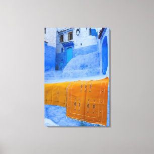 Rugs Draped On A Blue Wall Canvas Print