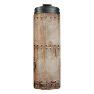 RUST AND TEXTURE ON METAL PLATE SIDES OF STAGED SH THERMAL TUMBLER