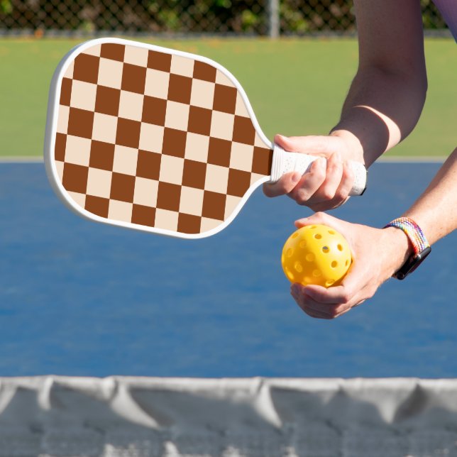 Rust brown and beige chequerboard pattern pickleball paddle (Insitu)