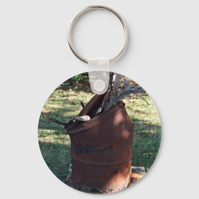 Rusted garbage can in grassy landscape key ring (Front)