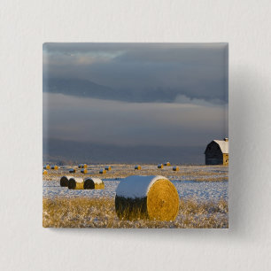 Rustic barn and hay bales after a fresh snow 3 15 cm square badge