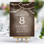 Rustic Brown Tree String Of Lights Wedding Table Number<br><div class="desc">Illuminate your rustic wedding reception with these enchanting table numbers. Featuring a majestic woodland tree silhouette adorned with twinkling string lights against a warm brown backdrop, these table numbers add a touch of magic to your special day. Perfect for outdoor or indoor celebrations, they create a cosy and inviting atmosphere...</div>