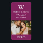 Rustic Burgundy Red Wedding Monogram Wine Photo<br><div class="desc">Rustic chic wedding wine bottle favour stickers feature a married monogram of the bride and groom names and last name initial,  wedding date,  and type of wine,  paired with a photo of the bride and groom. Burgundy red / purple background.</div>