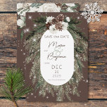 Rustic Cocoa Pine Winter Sparkle Wedding Save The Date<br><div class="desc">This design features a rustic green pine and pinecone bouquet on a cocoa background with white flowers. It is accented with a white sparkle overlay to illustrate the magic of the beautiful winter holidays. Perfect for a Christmas or winter wedding. This card is part of the Rustic Cocoa Pine Winter...</div>