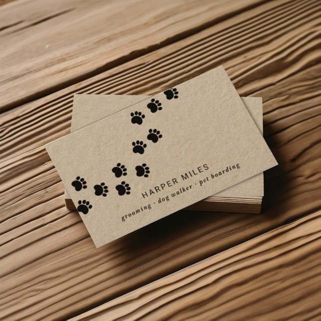 Rustic dog sitter paw path business card (Rustic professional business card on real brown kraft paper featuring a paw path)