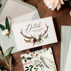 Rustic foliage, floral and stag wedding details save the date