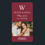 Rustic Maroon Red Wedding Monogram Wine Photo<br><div class="desc">Rustic chic wedding wine bottle favour stickers feature a married monogram of the bride and groom names and last name initial,  wedding date,  and type of wine,  paired with a photo of the bride and groom. Ivory text and earthy red background colour.</div>