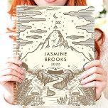 Rustic Mountain Landscape Custom Name Planner<br><div class="desc">This charming design features a hand-drawn mountain landscape with intricate details of ferns, mushrooms, and a winding river, all in earthy brown tones. The personalised name and year add a thoughtful touch, making it perfect for nature lovers and adventurers. Ideal for journalling, goal-setting, or daily planning with an inspiring and...</div>