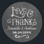 Rustic Script Love and Thanks Chalkboard Classic Round Sticker<br><div class="desc">Your guests will love this rustic chalkboard "Love and Thanks" monogram round sticker. Charming white calligraphy and whimsical hand-drawn style lettering display "Love and Thanks" with the couple's names and wedding date against a chalkboard-style background. Decorative flourishes add a playful, handcrafted touch. A versatile accent for favour bags, gift boxes,...</div>