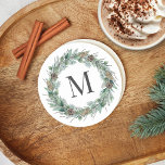 Rustic Winter Greenery Monogram Initial Wreath Round Paper Coaster<br><div class="desc">Elegant round white holiday drink coaster design features a rustic chic white wood grain background with a wreath of winter watercolor greenery framing a family / last name monogram initial. Includes a white background colour.</div>