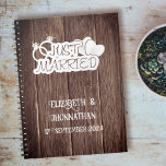 Rustic Wood Just Married  Elegant Wedding Planner  Notebook<br><div class="desc">Plan your special day with style and grace using our Rustic Wood Just Married Elegant Wedding Planner Notebook! The rustic wood texture sets the perfect backdrop for a timeless celebration. Adorned with an elegant 'Just Married' logo featuring hearts and wedding rings, this planner is a symbol of love. Personalise it...</div>