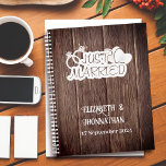 Rustic Wood White Just Married Elegant Weddings Planner<br><div class="desc">Plan your dream wedding with our Rustic Wood White Just Married Elegant Weddings Planner! The front design features a rustic wood texture background adorned with a white 'Just Married' logo, hearts, and wedding rings. Personalise it with the names of the bride and groom, along with the wedding date in elegant...</div>