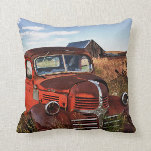 Rusting orange Dodge truck with abandoned farm Cushion