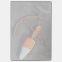 Rusty Anchor And Buoy On A Beach