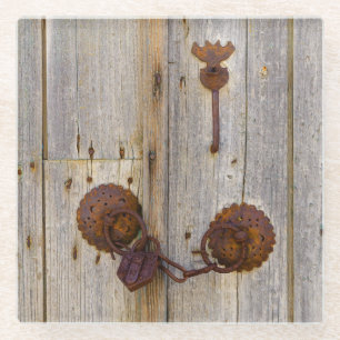 Rusty vintage old iron padlock on a wooden door -- glass coaster