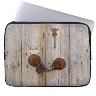 Rusty vintage old iron padlock on a wooden door -. laptop sleeve