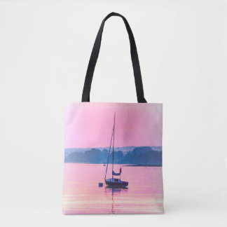 Sailboat floating in early morning light. tote bag