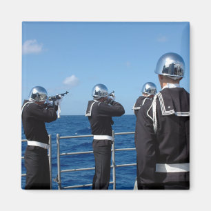 Sailors fire a gun salute during a burial-at-se magnet