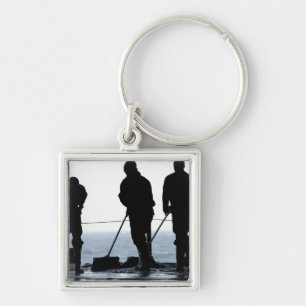 Sailors sweep out the hangar bay key ring