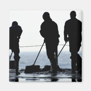 Sailors sweep out the hangar bay magnet