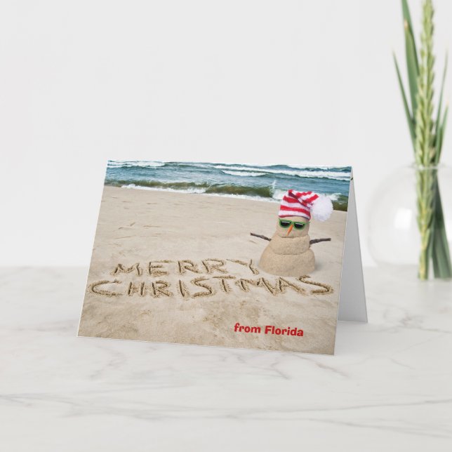 Sand snowman on beach with ocean holiday card (Front)