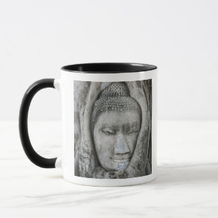 Sandstone head of Buddha surrounded by tree Mug