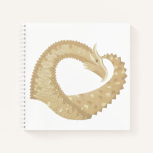 Sandstone heart dragon on white notebook