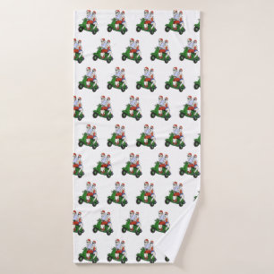 Santa and Mrs. Claus riding a scooter Bath Towel